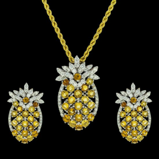 Gold pendant set with diamonds and yellow sapphires